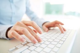 Hands of an office woman typing